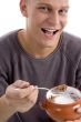 portrait of smiling male eating cornflakes