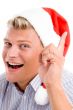 man pointing up with christmas hat