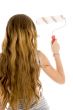back pose of girl with roller paint brush