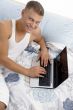 smiling man working on laptop