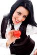 woman smiling and holding a small red heart