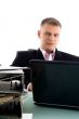 businessman with laptop and files
