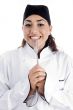smiling female chef showing fork