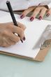 writing hands with notepad