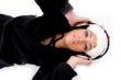 lying female listening music on headphone