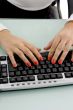front view of female hands working on keyboard