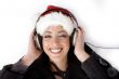 female listening music and wearing christmas hat