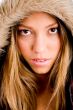 young woman with winter coat looking at camera