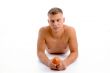 laying fit man with apple