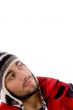 smart young guy in winter cap looking sideways
