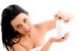female posing with lotion bottle on an background