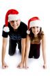 couple with christmas hat and looking at camera