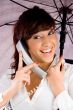 woman talking on phone and holding an umbrella