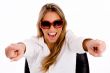 female with sunglasses pointing with both hand