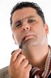 adult man in coat smoking tobacco pipe