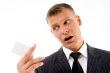 portrait of businessman looking business card