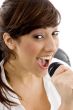 smiling female singing on microphone