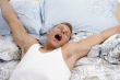 yawning man stretching his arms