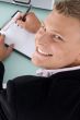 smiling employee with pen and writing board