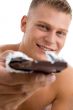 muscular man offering chocolate