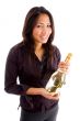 smiling asian woman holding champaign bottle