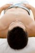 front view of man lying down for spa treatment