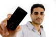 portrait of smiling man showing mobile