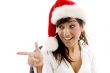 smiling businesswoman in christmas hat pointing si