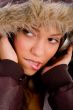 adult woman with woolen coat listening music