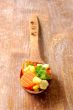 vegetablesi on a wooden spoon