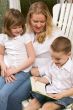 Young Boy Reads to His Mother and Sister