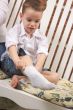 Adorable Young Boy Getting Socks On