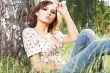girl lying down of grass