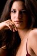 Lingery dressed brunette in a low key setting flirting