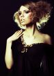 fashion model with curly hair in black tunic