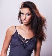 beautiful brunette model in blue blouse and whispering hair