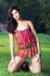 beautiful girl on grass in beautiful and colourful dress