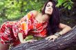 beautiful girl on grass in beautiful and colourful dress