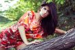 beautiful girl on grass in beautiful and colourful dress