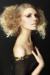 fashion model with curly hair in black tunic