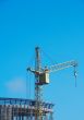 Lifting construction crane at blue sky