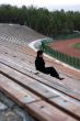 man sitting alone at stadium tribun