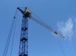 Lifting construction crane at blue sky