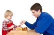 Man and girl play chess