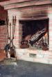 Fireplace with two old irons in it