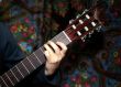 Hand on guitar fingerboard