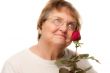 Attractive Senior Woman with Red Rose
