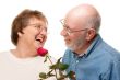 Happy Senior Couple with Red Rose