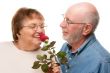 Happy Senior Couple with Red Rose