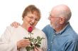Happy Senior Couple with Red Rose